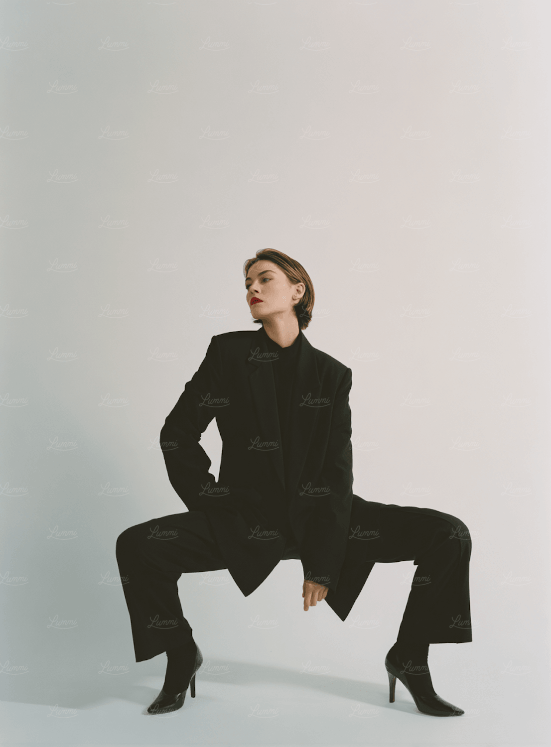 A model in an all-black outfit against a plain backdrop