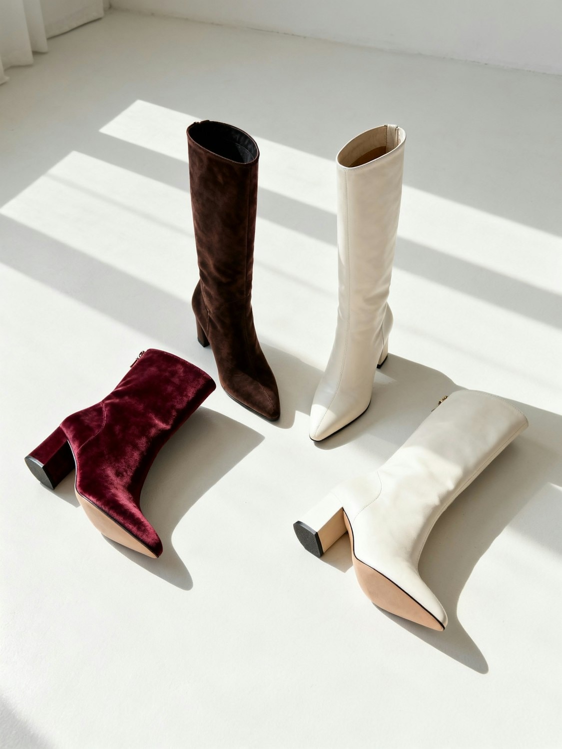 Leather boots lined up on a sunlit floor