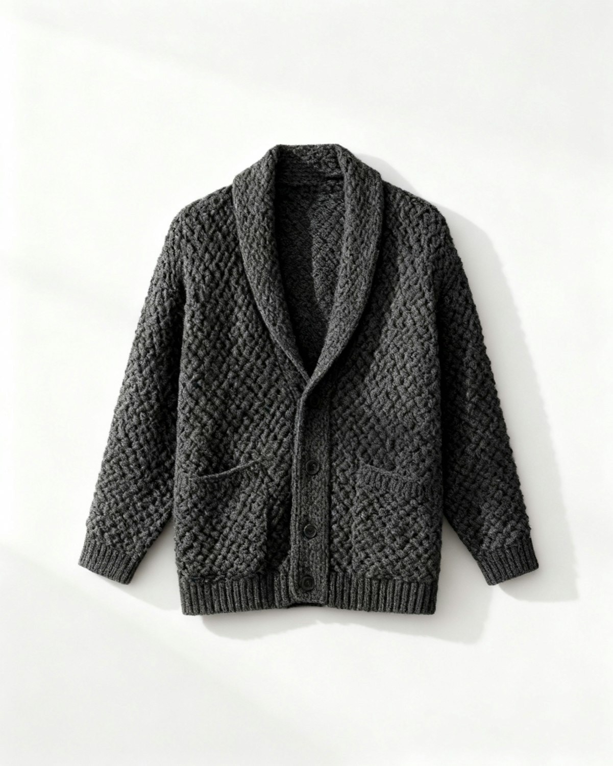 A textured knitted cardigan with a shawl collar and buttoned front