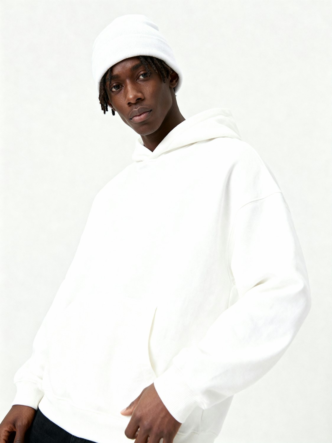 A model in a knit beanie and hoodie