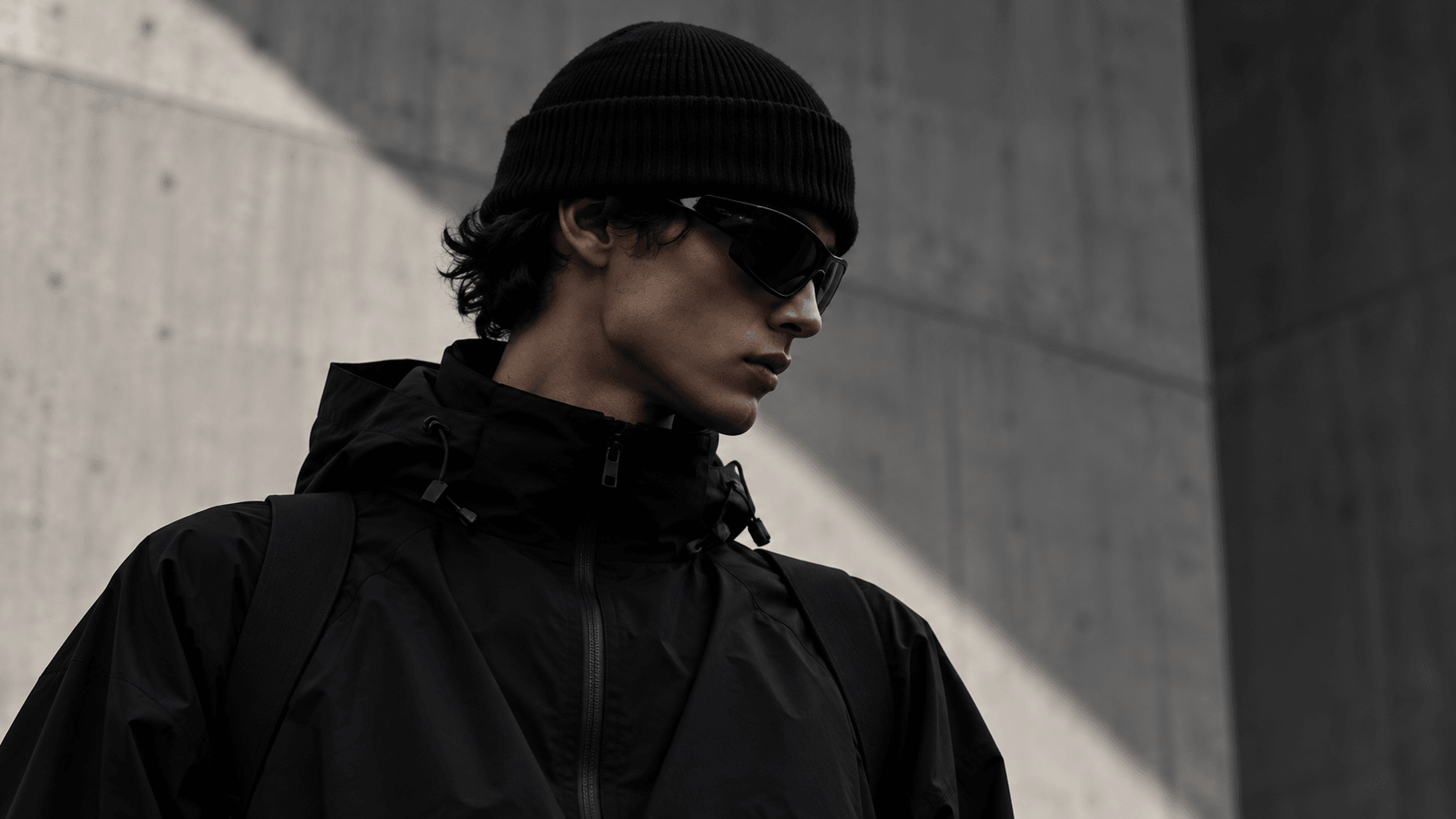 Kofi Mensah in a black beanie, sunglasses and hooded shell