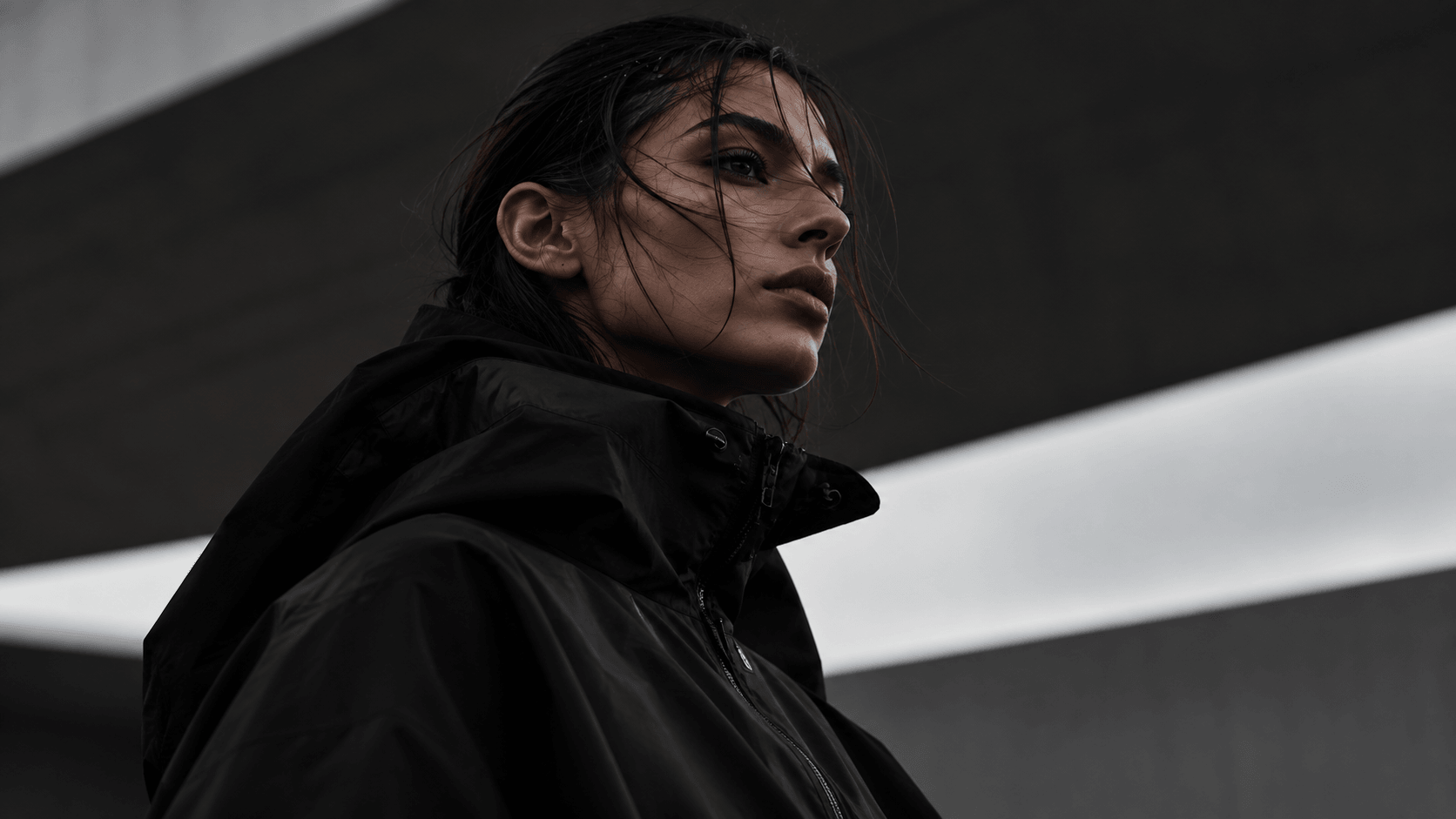 Aiko Tanaka in a high-collared black shell jacket